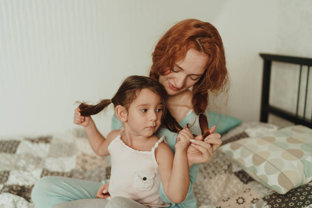 cozy photo session of beautiful happy mother and daughter, indoor - Фото, зображення