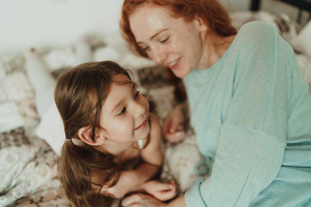 cozy photo session of beautiful happy mother and daughter, indoor - Photo, Image