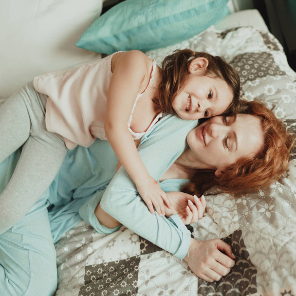 cozy photo session of beautiful happy mother and daughter, indoor - Фото, зображення