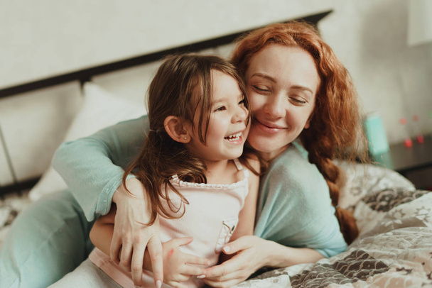 cozy photo session of beautiful happy mother and daughter, indoor - Photo, image
