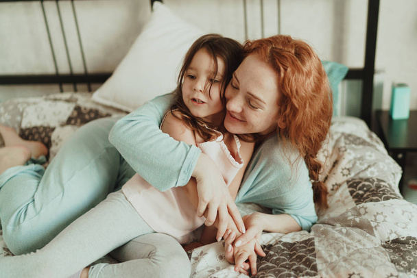 cozy photo session of beautiful happy mother and daughter, indoor - Zdjęcie, obraz