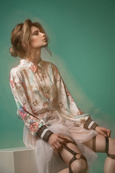 A girl, a model with a studio in a beautiful dress and a waist.  - Φωτογραφία, εικόνα