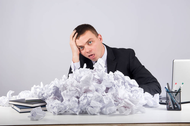Office, finances, internet, business, success and people concept-Upset businessman with crumpled paper in office on gray background - Photo, Image