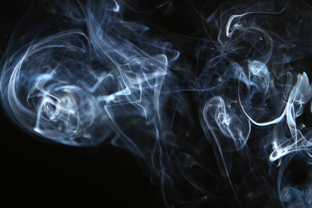 pretty flowing glowing blue smoke on the black background. - Photo, image