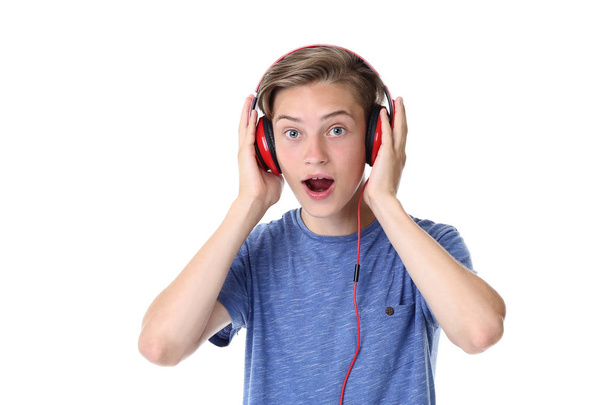 Cute teenager with headphones on white background - 写真・画像