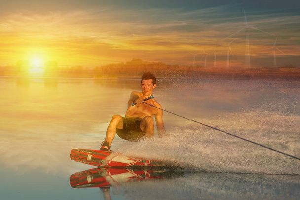 summer sports: wakeboarder speeding fast against the sunset. - Photo, Image