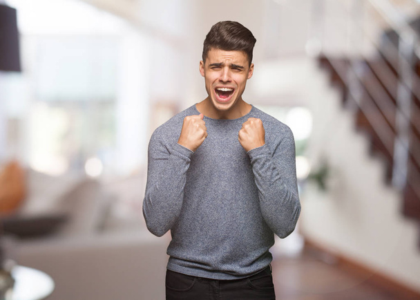 Young handsome man screaming very angry and aggressive - Photo, Image