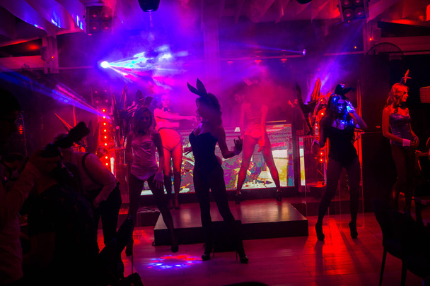 Odessa, Ukraine September 22, 2017: Official men magazine Playboy night party. Beautiful girls entertain guests, beauty pageant, dancing and light show. The audience actively resting at party - Photo, image