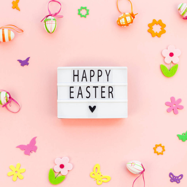 Creative Top view flat lay holiday composition Happy Easter text on lightbox pink paper background copy space Template Easter day seasonal pattern - Zdjęcie, obraz