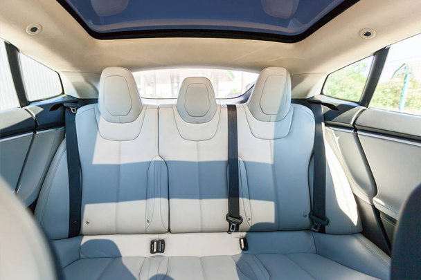 Back passenger seats in modern luxury car, frontal view, white leather - Foto, Imagem