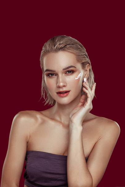 Photo model wearing open shoulder top promoting cosmetics - Фото, зображення
