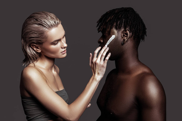 Two models using face cream while promoting cosmetics - Zdjęcie, obraz