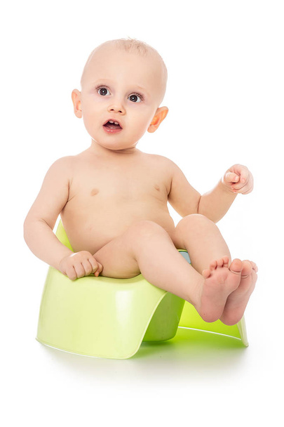 smiling happy baby. Kid on chamber pot on white background. banner for text or design. - Fotó, kép