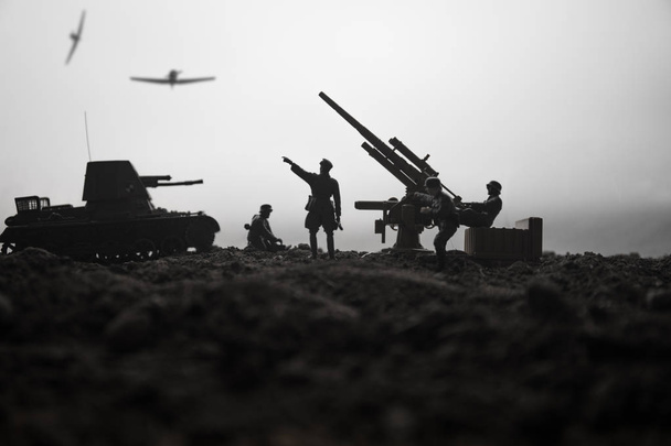 Un cañón antiaéreo y siluetas militares peleando escena en el fondo del cielo niebla de guerra. Fuerzas aéreas aliadas atacando posiciones alemanas. Obra de arte decorada escena. Enfoque selectivo
 - Foto, imagen