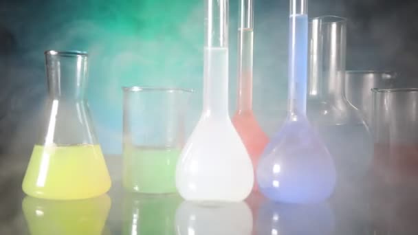 Pharmacy and chemistry theme. Test glass flask with solution in research laboratory. Science and medical background. Laboratory test tubes on dark toned background , science research equipment concept - Footage, Video