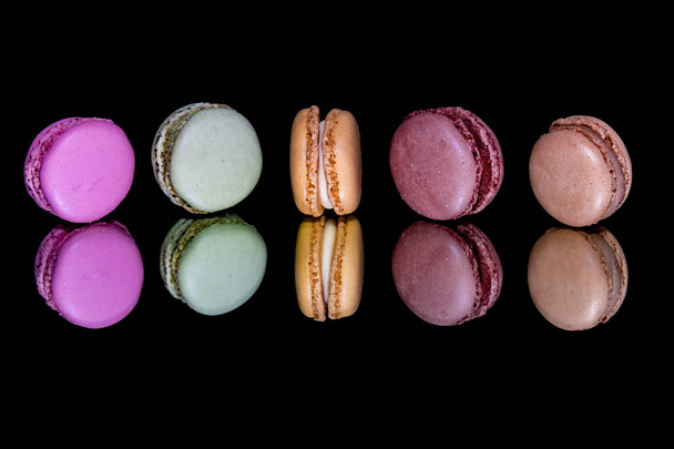 Tasty colorful macaroon homemade isolated on dark background - 写真・画像
