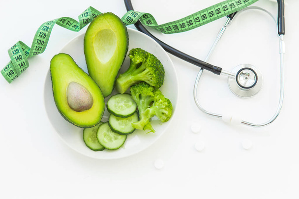 doctor nutritionist table. Healthy and healthy food, broccoli, pickers and avacado. Stethoscope and diet pills. Top View and flatlay, free space for text - Photo, Image