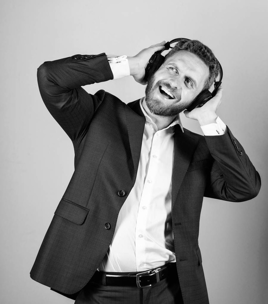 Man bearded face formal suit enjoy song. Playlist for office work. Music break during working day. Business man with headphones listening music. Businessman listen music and dance. Music and relax. - Foto, Imagem