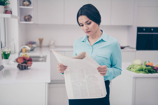 Portrait of her she nice adorable attractive charming elegant caucasian candid intelligent lady ceo boss chief wearing blue shirt reading article column in light white interior indoors - Fotó, kép