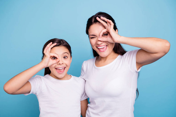 Close up photo beautiful two people brown haired mom little daughter friends look finger specs okey symbol silly screaming shouting wear white t-shirts isolated bright blue background - Fotoğraf, Görsel