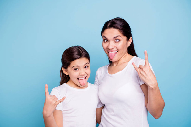 Close up photo beautiful two people brown haired mom little daughter friends hipsters mouth opened tongue out rock music lovers amazed wear white t-shirts isolated bright blue background - Fotó, kép