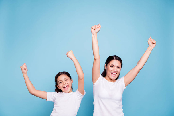 Close up photo cheer two people brown haired mum small little daughter hands arms air glad yell football fans free sale discount shopping buy buyer wear white t-shirts isolated bright blue background - Fotó, kép
