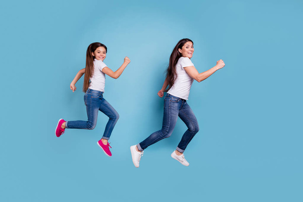 Full length body size profile side view of two nice sweet lovely attractive cheerful cheery funny slim sporty people in white t-shirt having fun isolated over blue pastel background - Foto, Bild