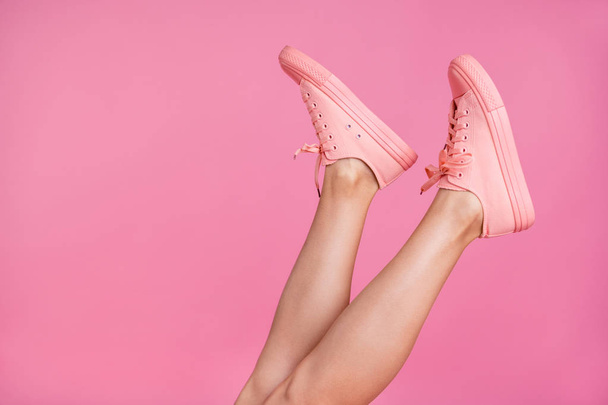 Cropped close-up image view photo of nice attractive feminine fit thin slim shaven legs active sport walk go steps trendy foot-wear isolated over pink pastel background - Foto, Imagem