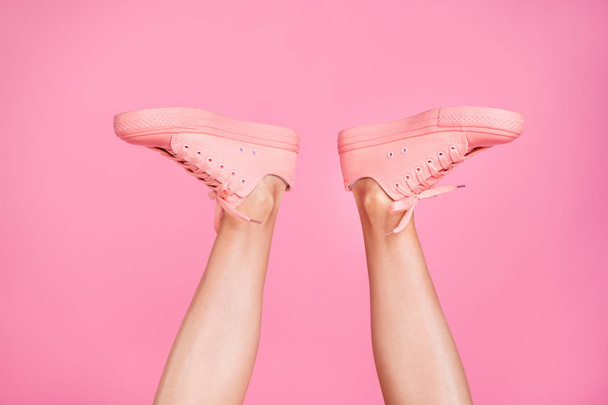 Cropped close-up image view photo concept of nice cool girlish fit slim thin shaven legs active sport walk go cozy comfort zone footgear sale discount isolated over pink pastel background - Фото, зображення