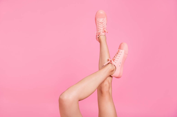 Cropped image view photo of nice cool girlish feminine fit thin slim adorable legs cozy comfort zone footgear cool lifestyle rest relax weekend isolated over pink pastel background - Photo, Image