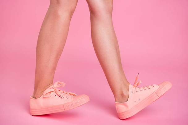 Cropped image view photo of nice attractive fit thin slim clean clear shaven healthy legs cozy comfort footgear funny walking sporty lifestyle step isolated over pink pastel background - Foto, Bild