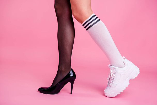 Cropped close-up profile side view photo of two girlish attractive different fit thin slim legs cozy comfort luxury chic sporty sportive comparison walking strolling isolated on pink pastel background - Foto, imagen