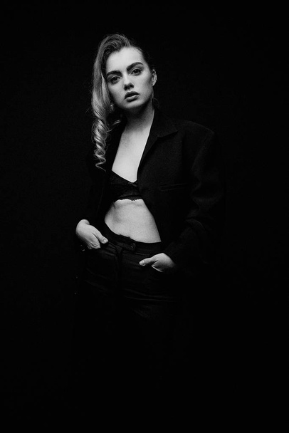 Beautiful Young Woman Posing  in black jacket  and bra - Фото, изображение