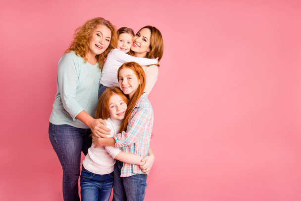 Close up family girlish present photo set foxy little girls mom granny five stand close tight smile glad vacation spend free time wear sweaters shirts pullovers isolated on rose background - Photo, Image