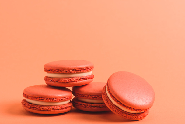 delicious coral macarons on purple background, color of 2019 concept - Photo, Image