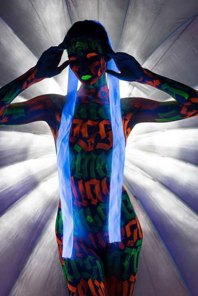 Naked woman in glowing neon signs on body  - Foto, afbeelding