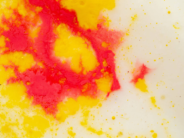 Yellow red pattern on bright background. Close up shot. Abstract background. Colourful abstract pattern of yellow and red paint. Paint splashes. Macro shot. Blurred background. - Foto, immagini