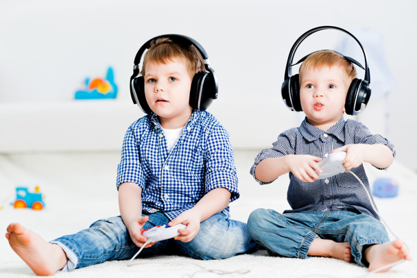 two brothers playing on a games console - Фото, зображення