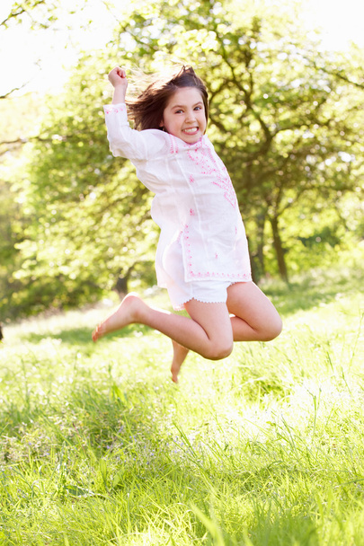 Young Girl Jumping In Summer Field - Photo, image