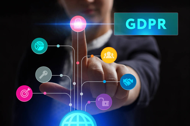The concept of business, technology, the Internet and the network. A young entrepreneur working on a virtual screen of the future and sees the inscription: GDPR - 写真・画像