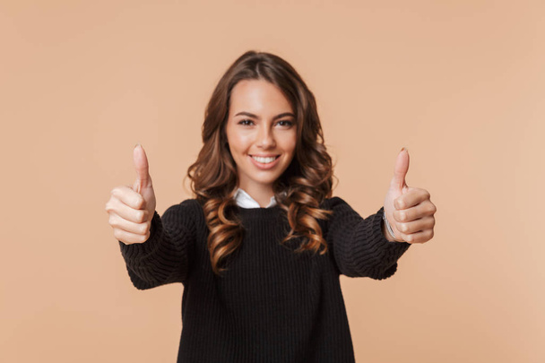 Image of a beautiful amazing happy emotional woman posing isolated showing thumbs up. - Foto, Imagem
