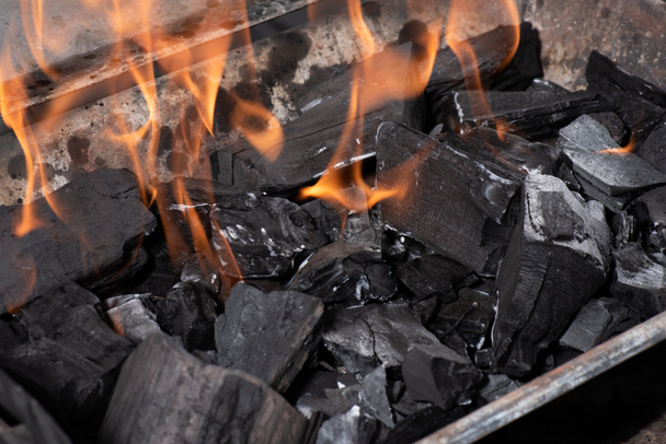 bright burning black coals in iron barbecue grill - Foto, Imagen
