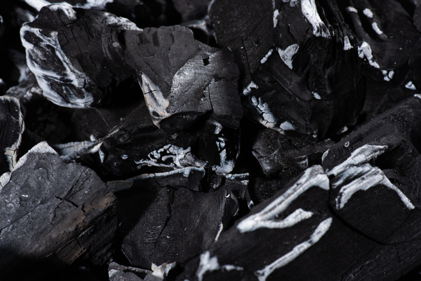 close up of black burnt textured charcoal with white ash - Photo, Image
