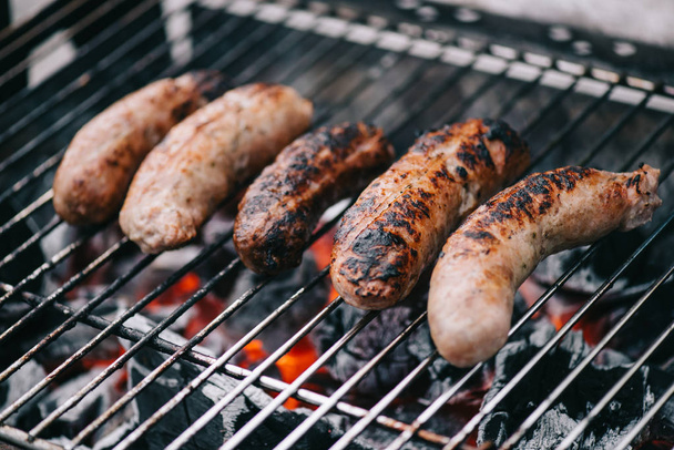 selective focus of grilled tasty sausages on bbq grill - Fotoğraf, Görsel