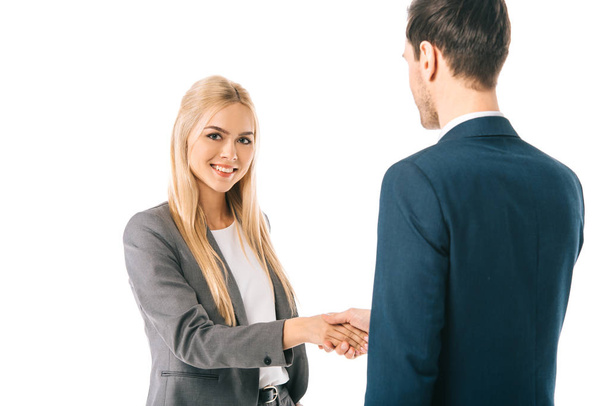 blonde businesswoman shaking hands with colleague and making deal isolated on white - Foto, Imagen