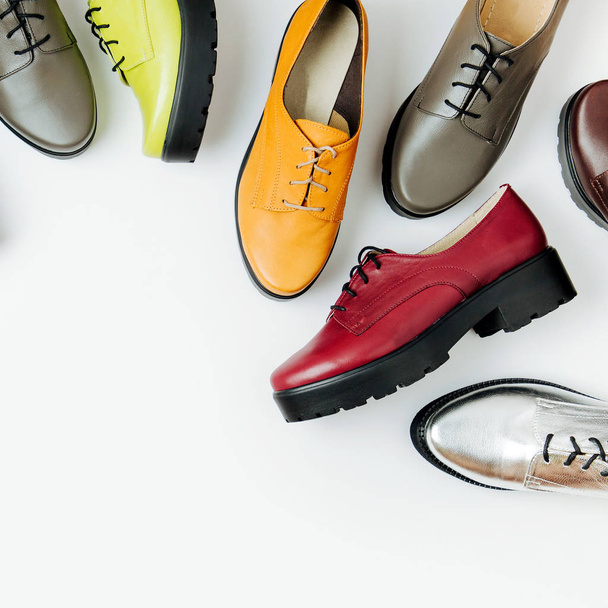 Stylish female spring or autumn shoes in various colors. Beauty and fashion concept. Flat lay, top view - 写真・画像