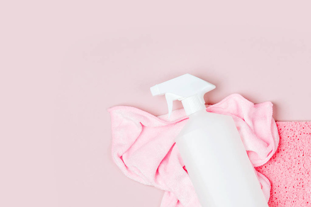 Detergents and cleaning accessories  in pink color.  Cleaning service concept. Flat lay, Top view. - Zdjęcie, obraz