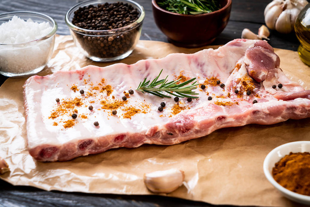 Fresh raw pork ribs ready for roasting with ingredients - 写真・画像