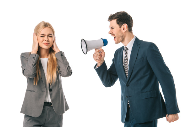 emotional businessman yelling into megaphone at frightened businesswoman isolated on white - Foto, imagen