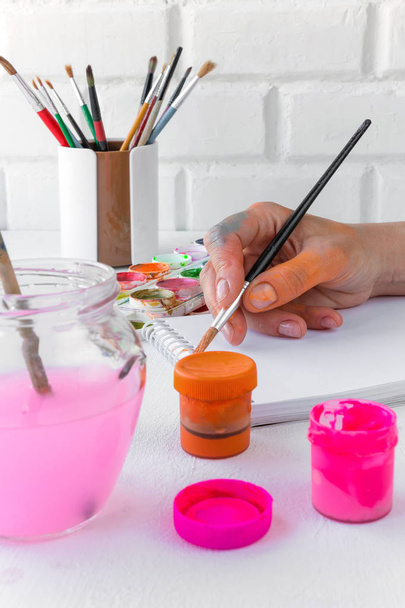 Paper, watercolors, paint brush and some art stuff on wooden table  - Valokuva, kuva